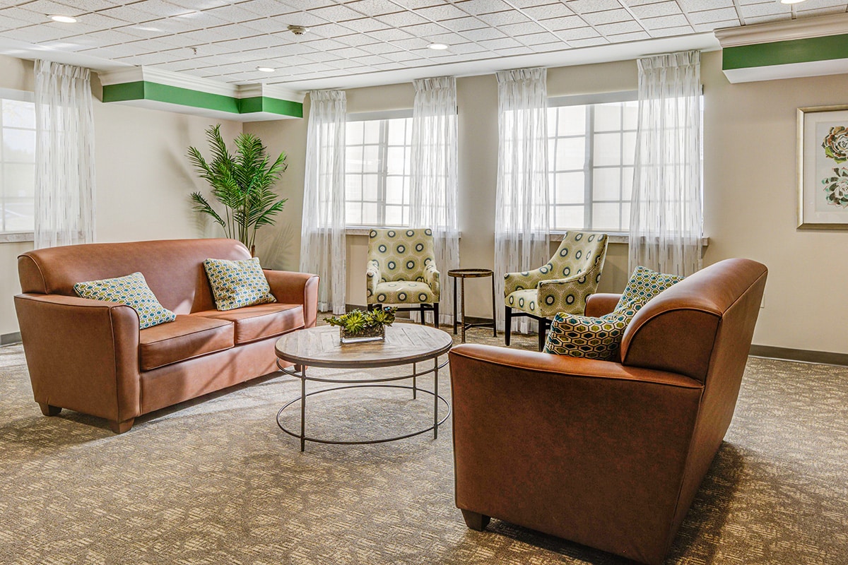 Reception area with brown leather sofas and club chairs.