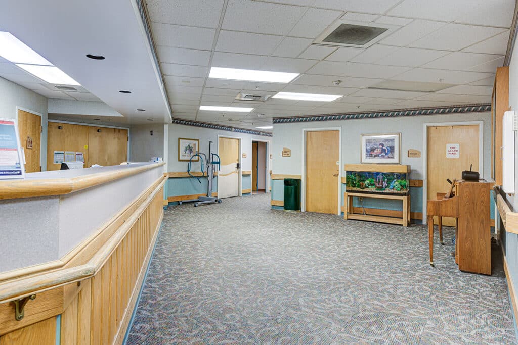 Lobby of facility with fish tank and piano
