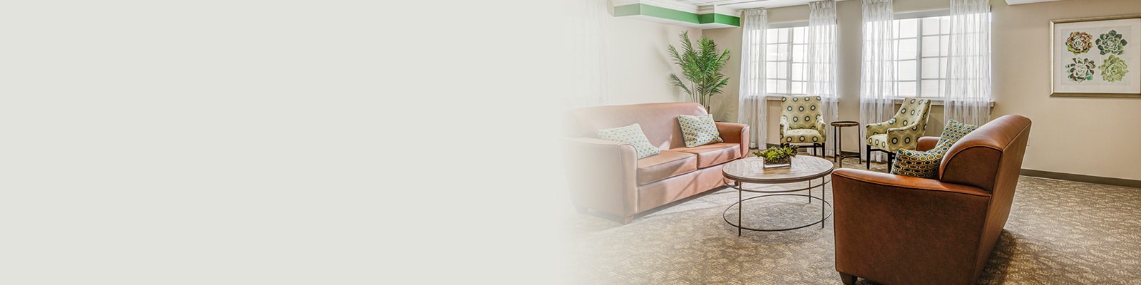 Reception area with brown leather sofas and club chairs.